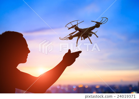 silhouette of man take drone silhouette of man take drone 24019371