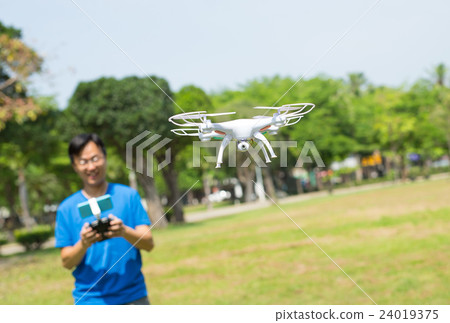 man play drone in park man play drone in park 24019375