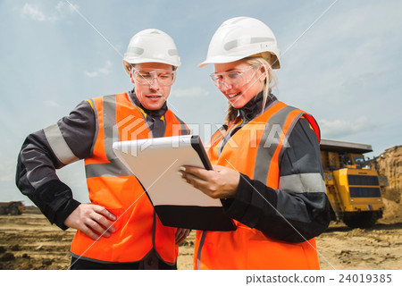 Two people working Two people working 24019385