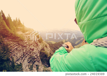 checking the altimeter on sports watch  24019389