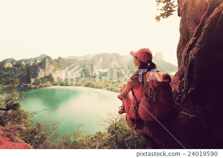 woman hiker at sunrise mountain peak cliff. woman hiker at sunrise mountain peak cliff. 24019590