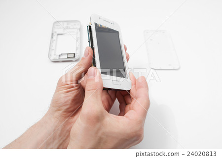 Smartphone dismantling on white background 24020813