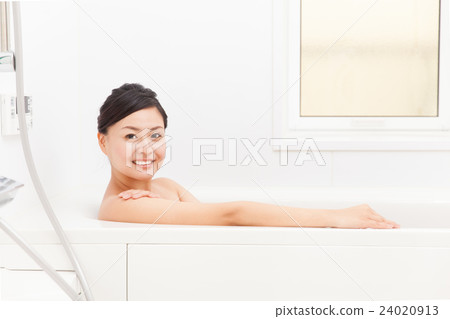 A woman taking a bath A woman taking a bath 24020913