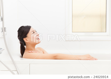 A woman taking a bath 24020914