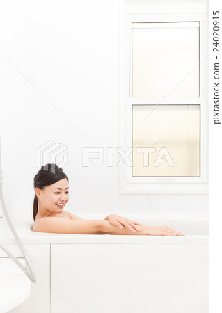 A woman taking a bath 24020915