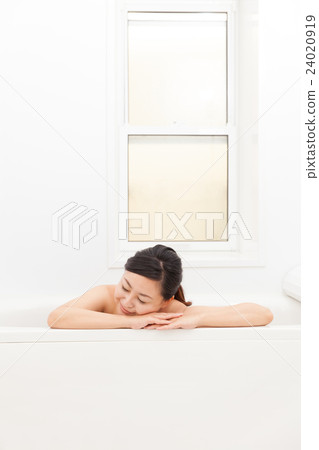 A woman taking a bath 24020919