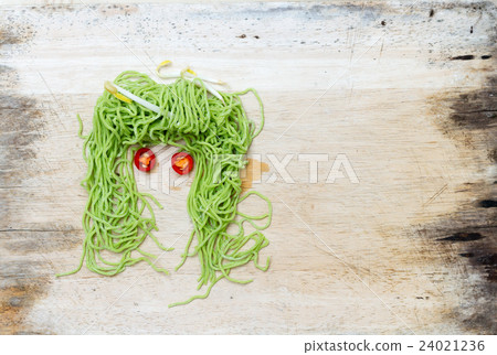 faces on wood background made 24021236