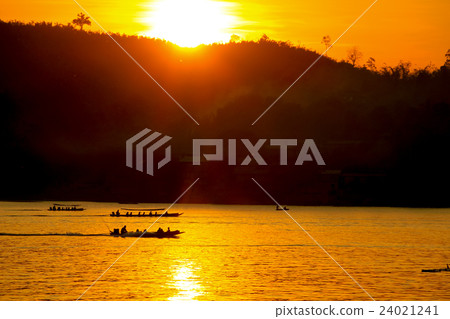 sunset behind the mountain with boat running sunset behind the mountain with boat running 24021241