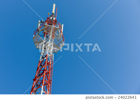 Mobile phone base station tower in blue sky. Mobile phone base station tower in blue sky. 24022641