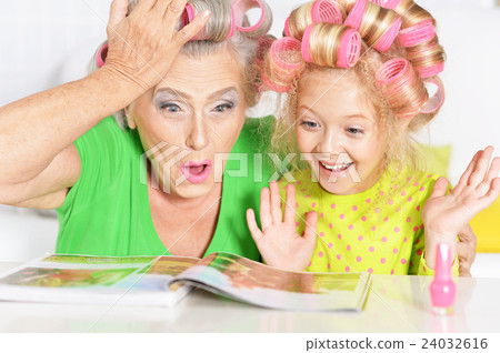 Senior woman and granddaughter painting nails Senior woman and granddaughter painting nails 24032616