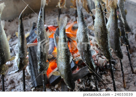 Charcoal grilling of river fish Charcoal grilling of river fish 24033039