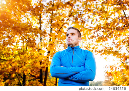 Young handsome hipster runner outside in sunny 24034856