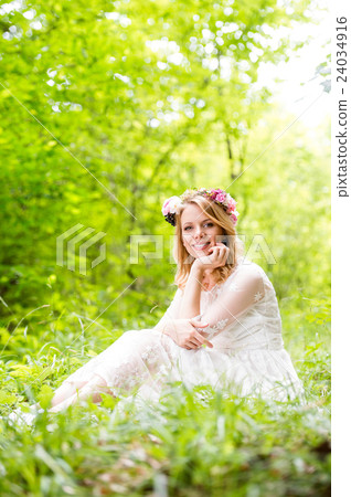 Bride in wedding dress with flower wreath, green Bride in wedding dress with flower wreath, green 24034916