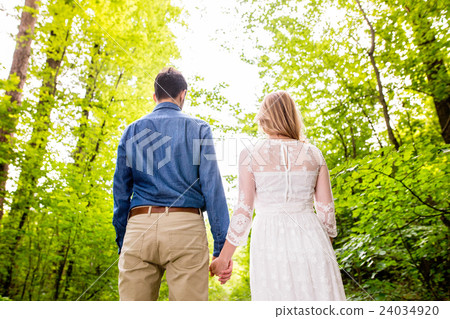 Beautiful wedding couple outside in green forest 24034920