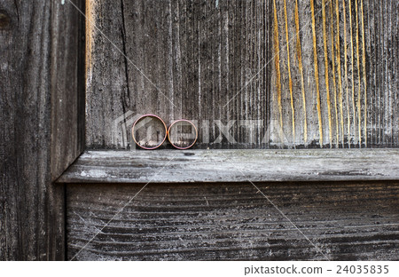 Wedding rings on a gray wooden background. Wedding rings on a gray wooden background. 24035835