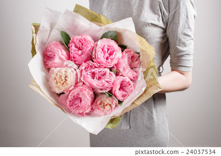 Florist girl with peony flowers or pink garden 24037534