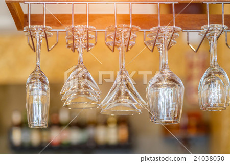 Empty glasses for wine above a bar rack 24038050