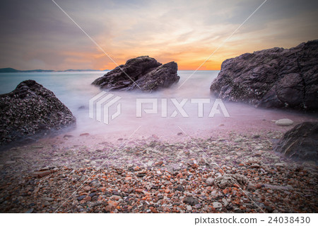 Soft waves of ocean in sunset with stones  24038430
