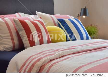 Modern bedroom with colorful pillows on beds 24039640