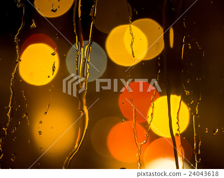 Raindrops on a window pane at night 24043618