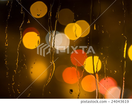 Raindrops on a window pane at night 24043619