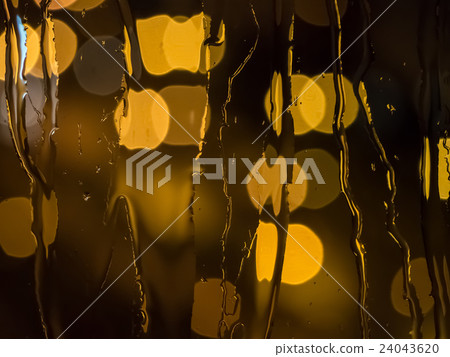 Raindrops on a window pane at night 24043620