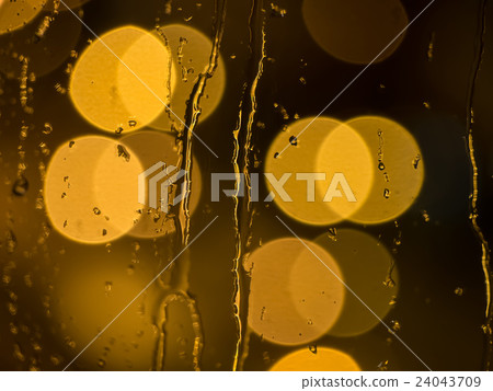 Raindrops on a window pane at night 24043709