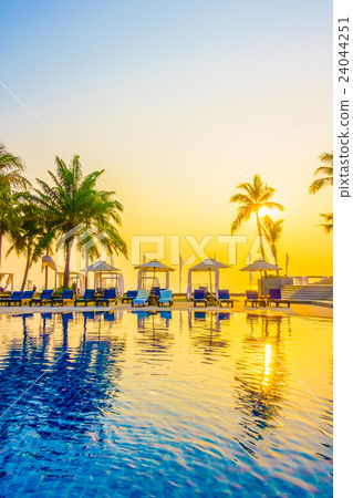 Beautiful Silhouette palm tree with umbrella and chair Beautiful Silhouette palm tree with umbrella and chair 24044251