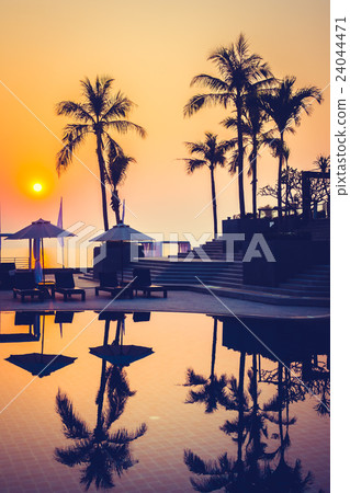 Beautiful Silhouette palm tree with umbrella and chair Beautiful Silhouette palm tree with umbrella and chair 24044471