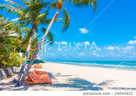 Umbrella and chair on the beach Umbrella and chair on the beach 24044822