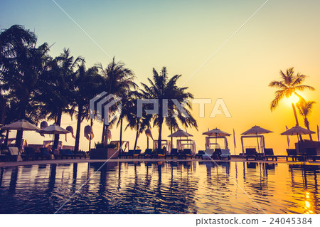 Beautiful Silhouette palm tree with umbrella and chair Beautiful Silhouette palm tree with umbrella and chair 24045384