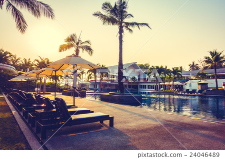 Beautiful Silhouette palm tree with umbrella and chair Beautiful Silhouette palm tree with umbrella and chair 24046489