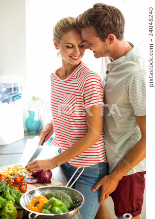 Romantic couple in kitchen Romantic couple in kitchen 24048240