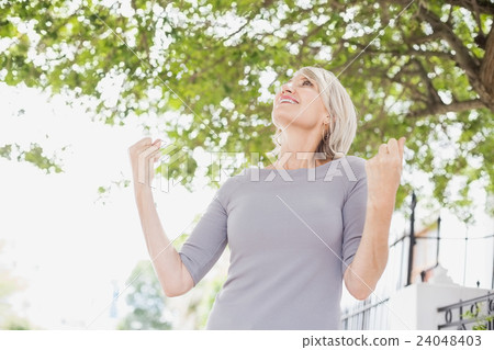 Happy woman with raised fists Happy woman with raised fists 24048403