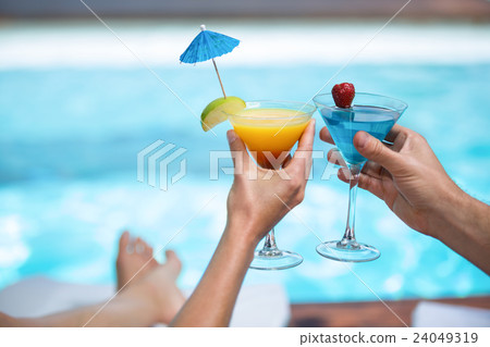 Hands of couple toasting martini glass Hands of couple toasting martini glass 24049319