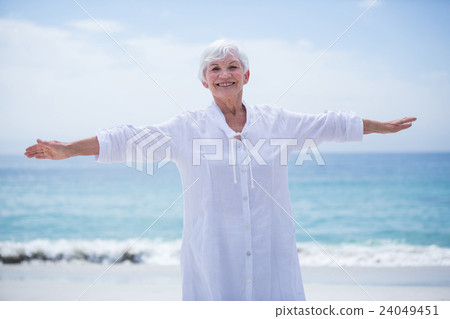 Portrait of senior woman smiling while exercising Portrait of senior woman smiling while exercising 24049451