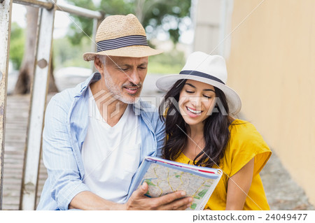Happy couple looking at map Happy couple looking at map 24049477
