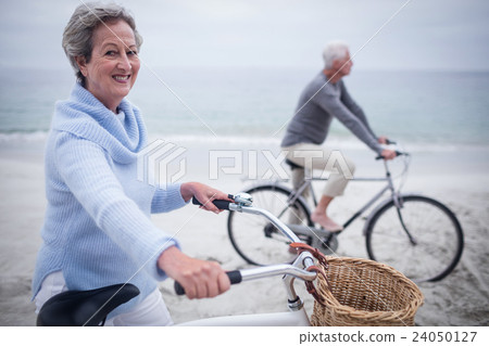 Senior couple having ride with their bike 24050127