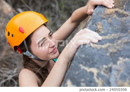 High angle view of beautiful woman climbing rock High angle view of beautiful woman climbing rock 24050306