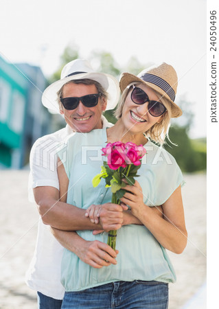 Happy couple holding roses 24050496