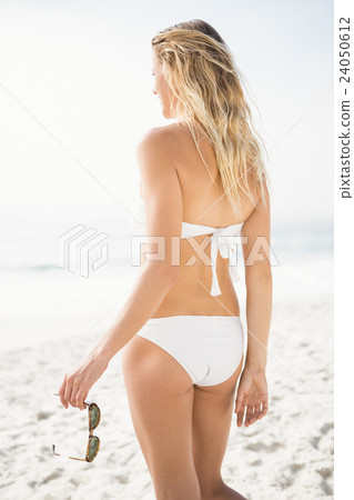 Blonde woman posing on the beach Blonde woman posing on the beach 24050612