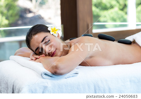 Beautiful woman receiving stone massage 24050683