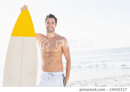 Man holding surfboard on the beach 24050727