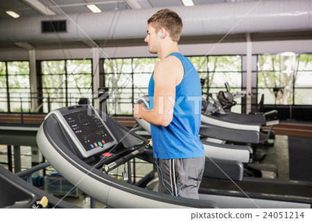 Man on treadmill listening to music Man on treadmill listening to music 24051214