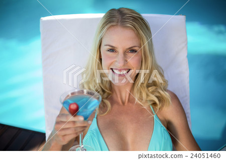 Beautiful woman in bikini relaxing on a sun lounger Beautiful woman in bikini relaxing on a sun lounger 24051460