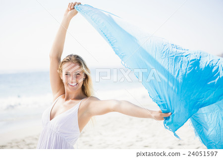 Blonde woman relaxing on the beach Blonde woman relaxing on the beach 24051597