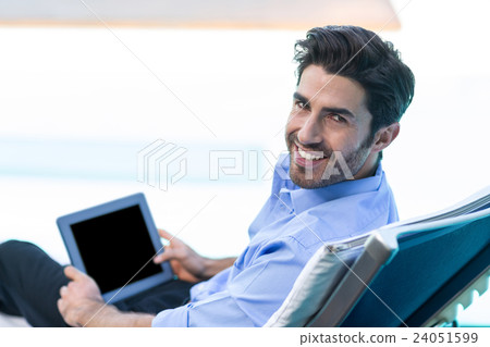 Smart man using digital tablet near pool Smart man using digital tablet near pool 24051599
