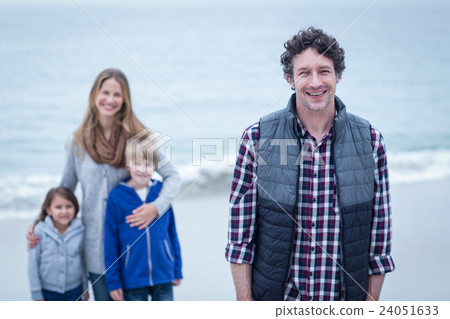 Father with mother and children at beach  24051633