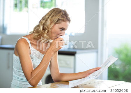 Beautiful woman reading newspaper Beautiful woman reading newspaper 24052608