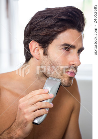 Man shaving with trimmer Man shaving with trimmer 24052695